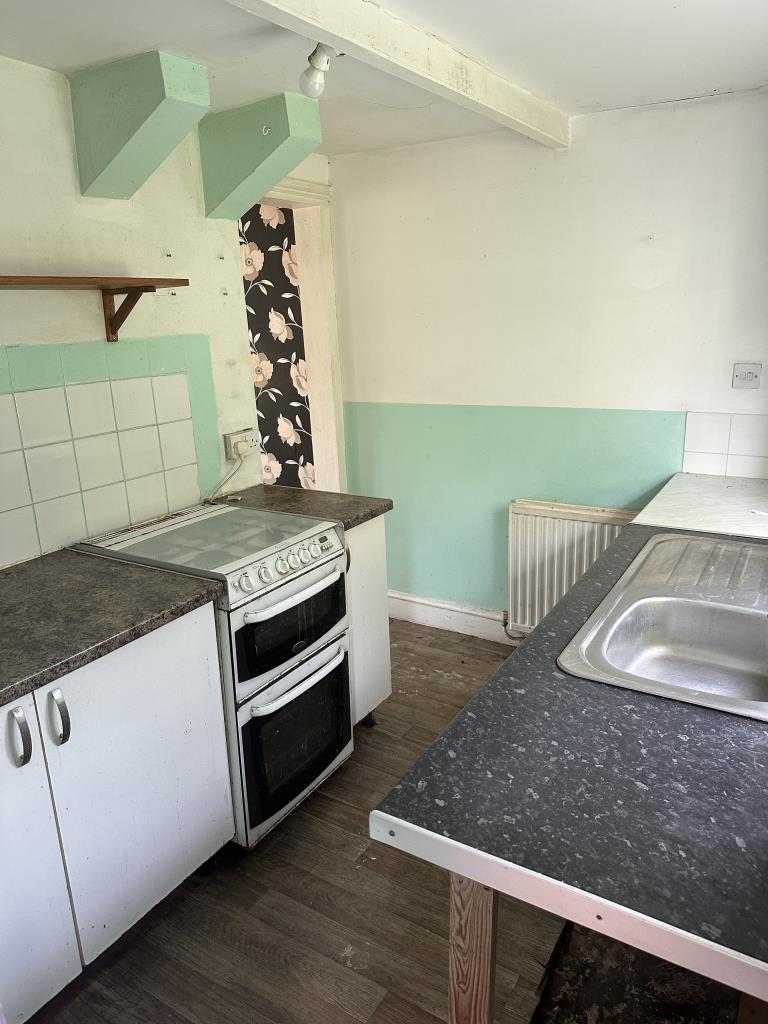 Lot: 99 - END-TERRACE COTTAGE FOR IMPROVEMENT - Kitchen with door to rear